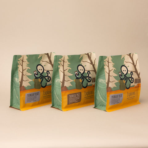 Three Sipnode Experimental coffee bags featuring Tropical Mist, Moonlight Decaf, and specialty coffee packaging displayed together on a white background.