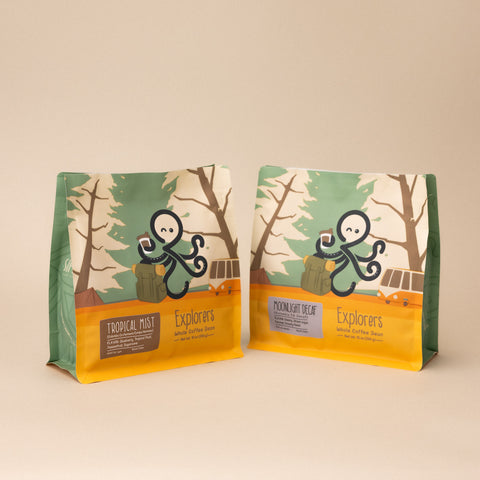Sipnode Explorers coffee collection featuring Tropical Mist and Moonlight Decaf whole bean coffee bags displayed side by side.