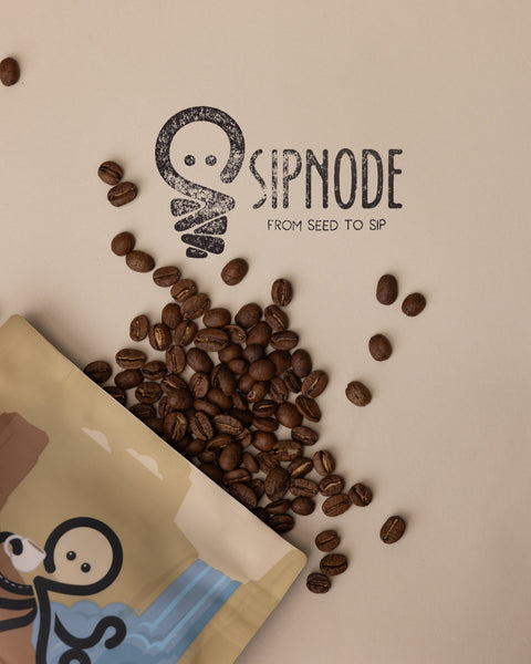 Sipnode coffee beans spilled from a Blend coffee bag beside the Sipnode logo.