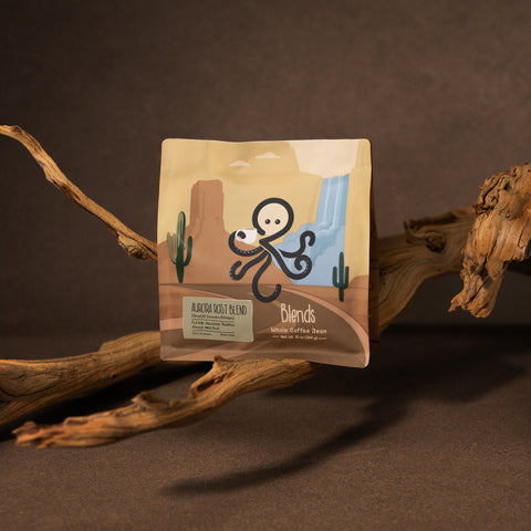 Aurora Roast Blend whole bean coffee displayed with natural wood branches