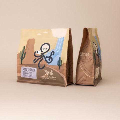 Front and side view of Sipnode Summit Camp Blend whole bean coffee bag featuring a dark roast blend from Guatemala and Ethiopia.